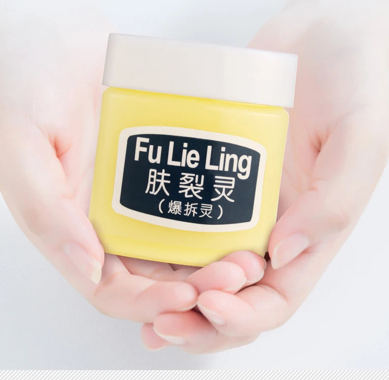 Yellow hand cream jar held in hands, labeled Fu Lie Ling, designed for skin moisturizing and nourishment.