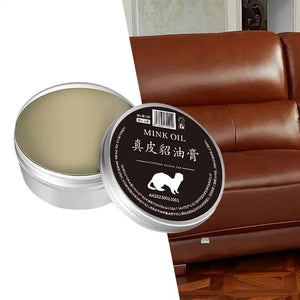 Mink oil cream for leather care with a leather sofa background, perfect for conditioning and preserving leather surfaces.