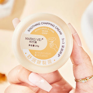 Soothing chapping cream in a 20g container held by a hand with long nails, featuring moisturizing benefits.