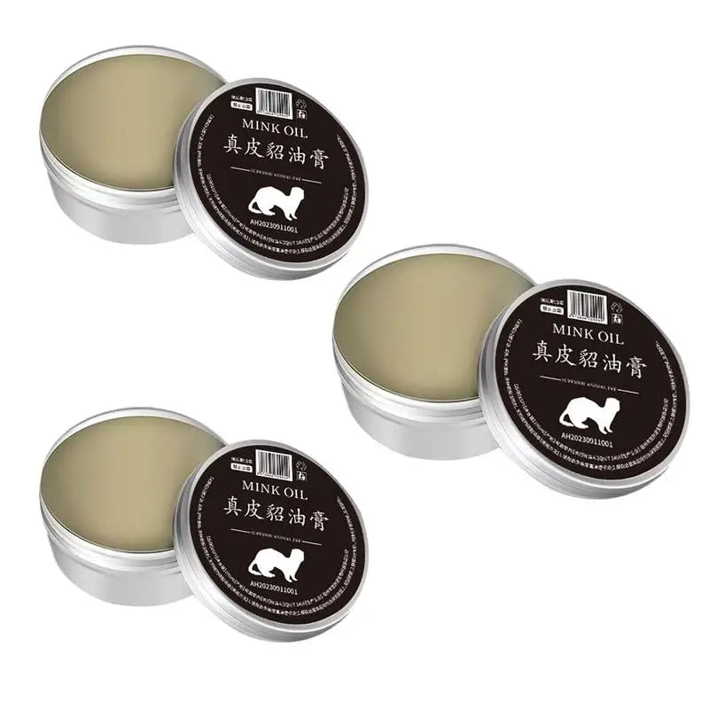 Two tins of mink oil conditioner for leather care, ideal for restoring and protecting leather goods.