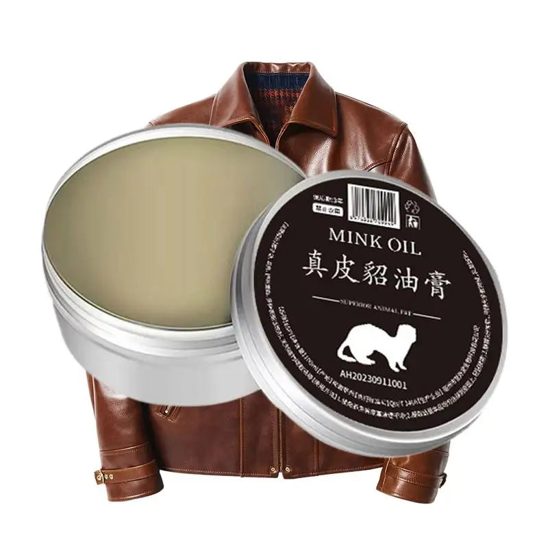 Mink oil cream for leather conditioning beside a brown leather jacket, ideal for restoring and preserving leather items.