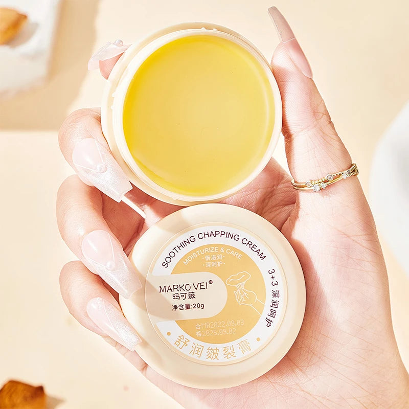 Soothing chapping cream in a hand, 20g container, moisturizing for dry skin on hands and feet.